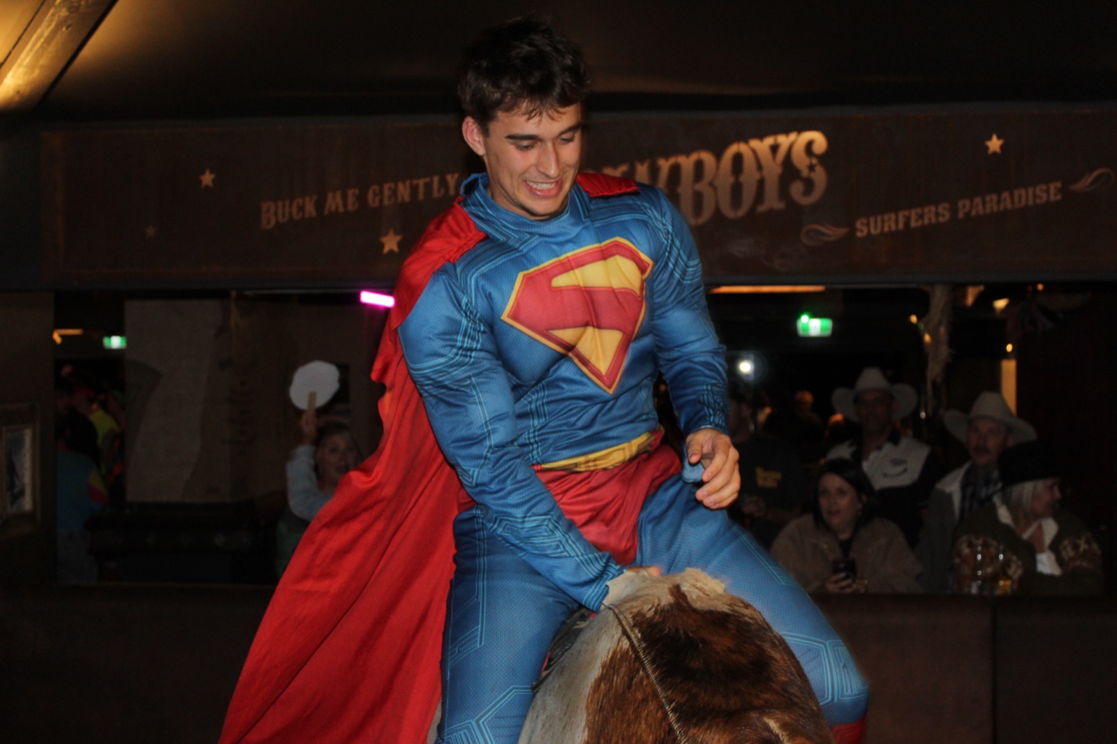 Rider in a Superman costume on the bull at Cowboys Surfers Paradise