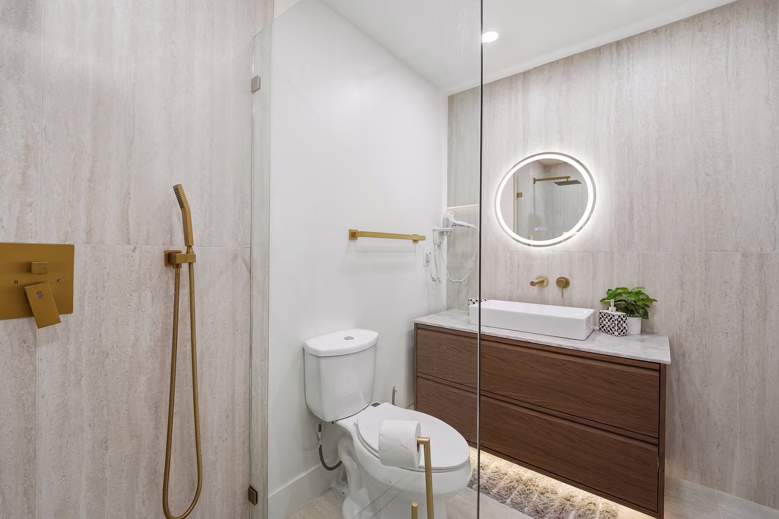 Modern bathroom with glass shower and wood vanity