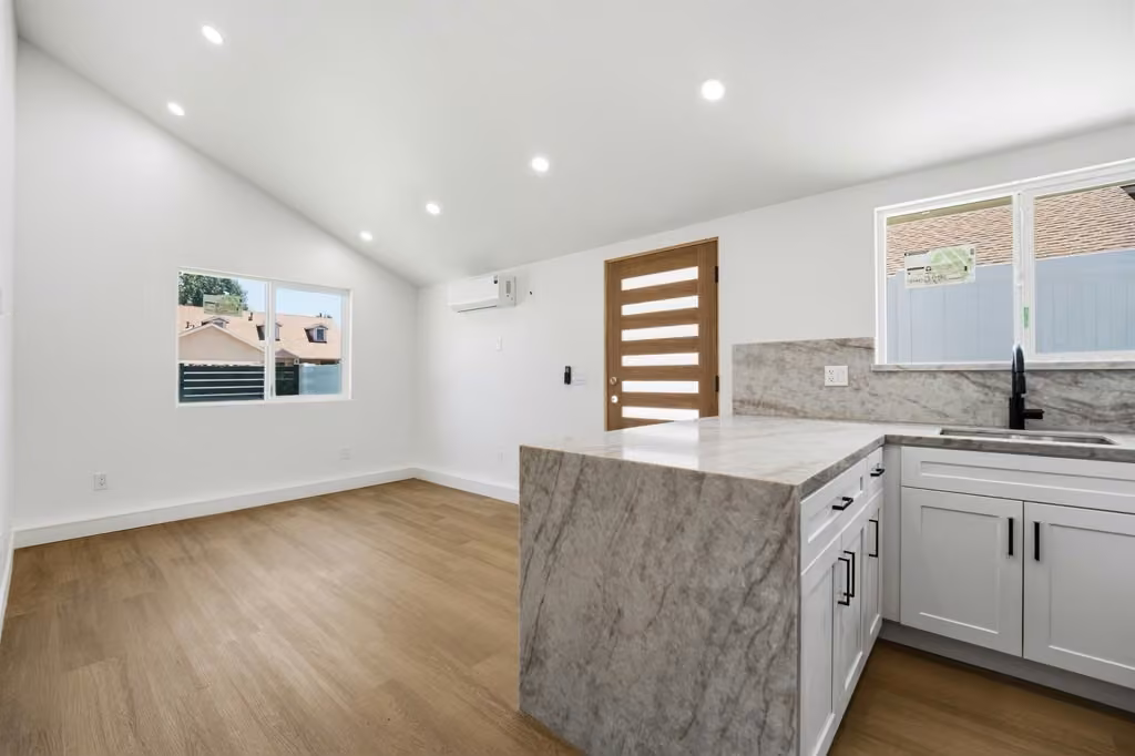 Bright open-concept kitchen with large marble island