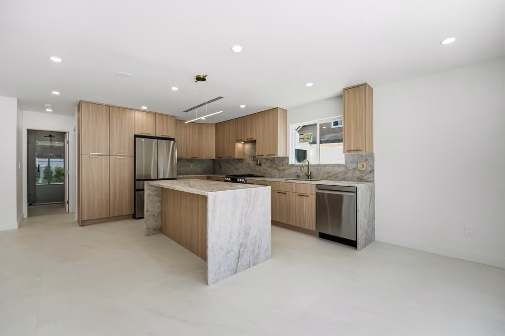 Open kitchen with wood cabinetry and central island