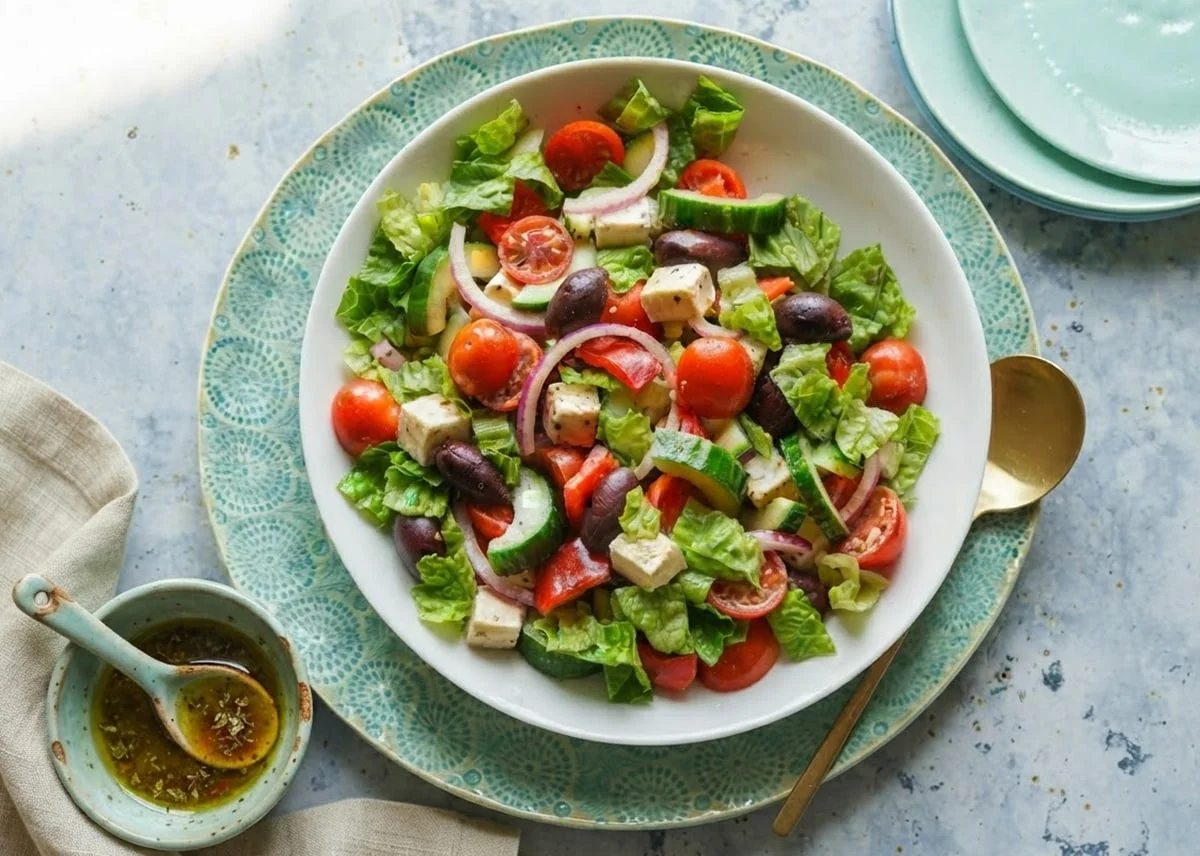Greek Salad with cherry tomatoes, cucumbers, red onion, feta cheese cubes, and Kalamata olives.