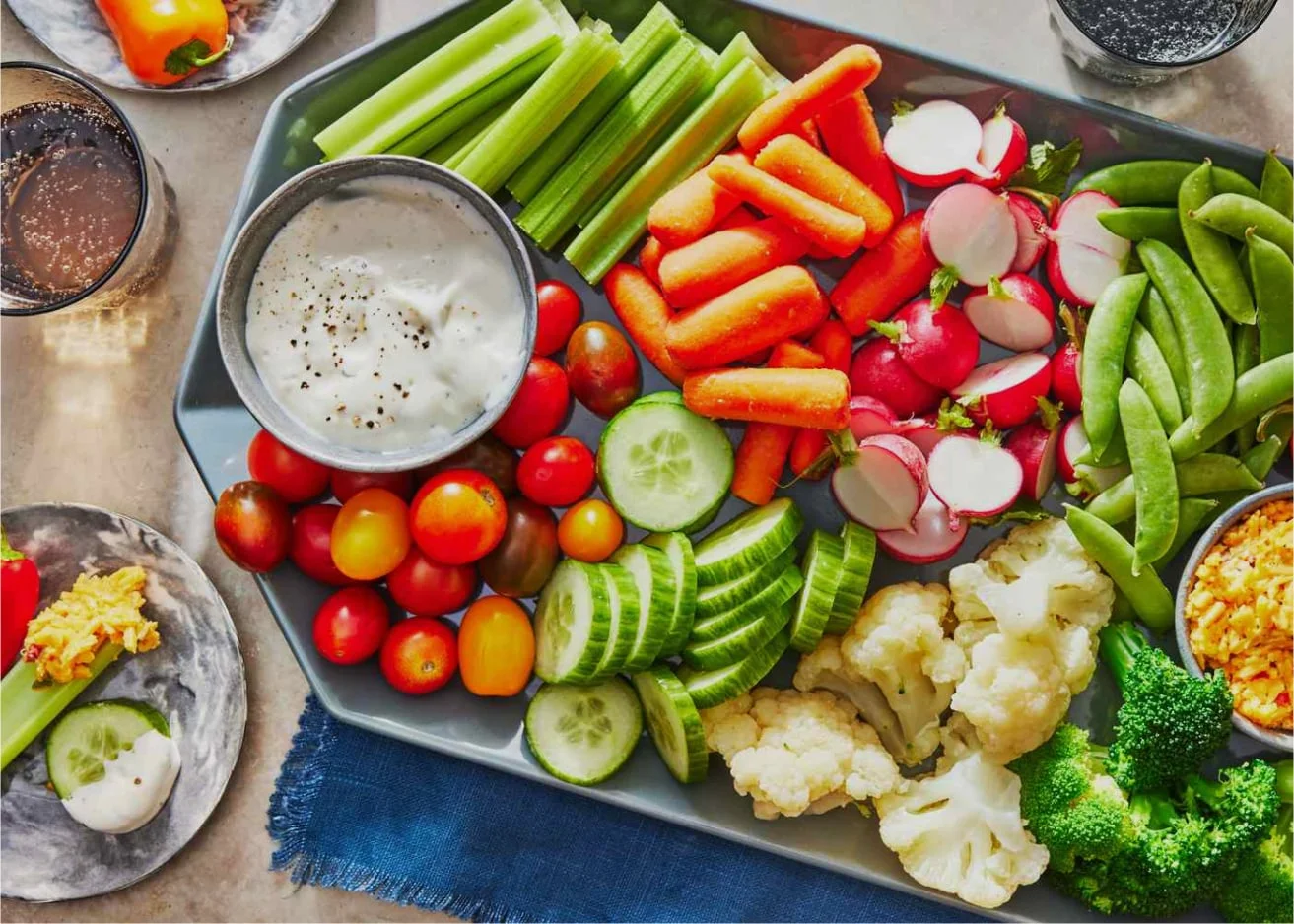Veggie Platter with fresh carrots, cucumbers, cherry tomatoes, celery, broccoli, and dip.