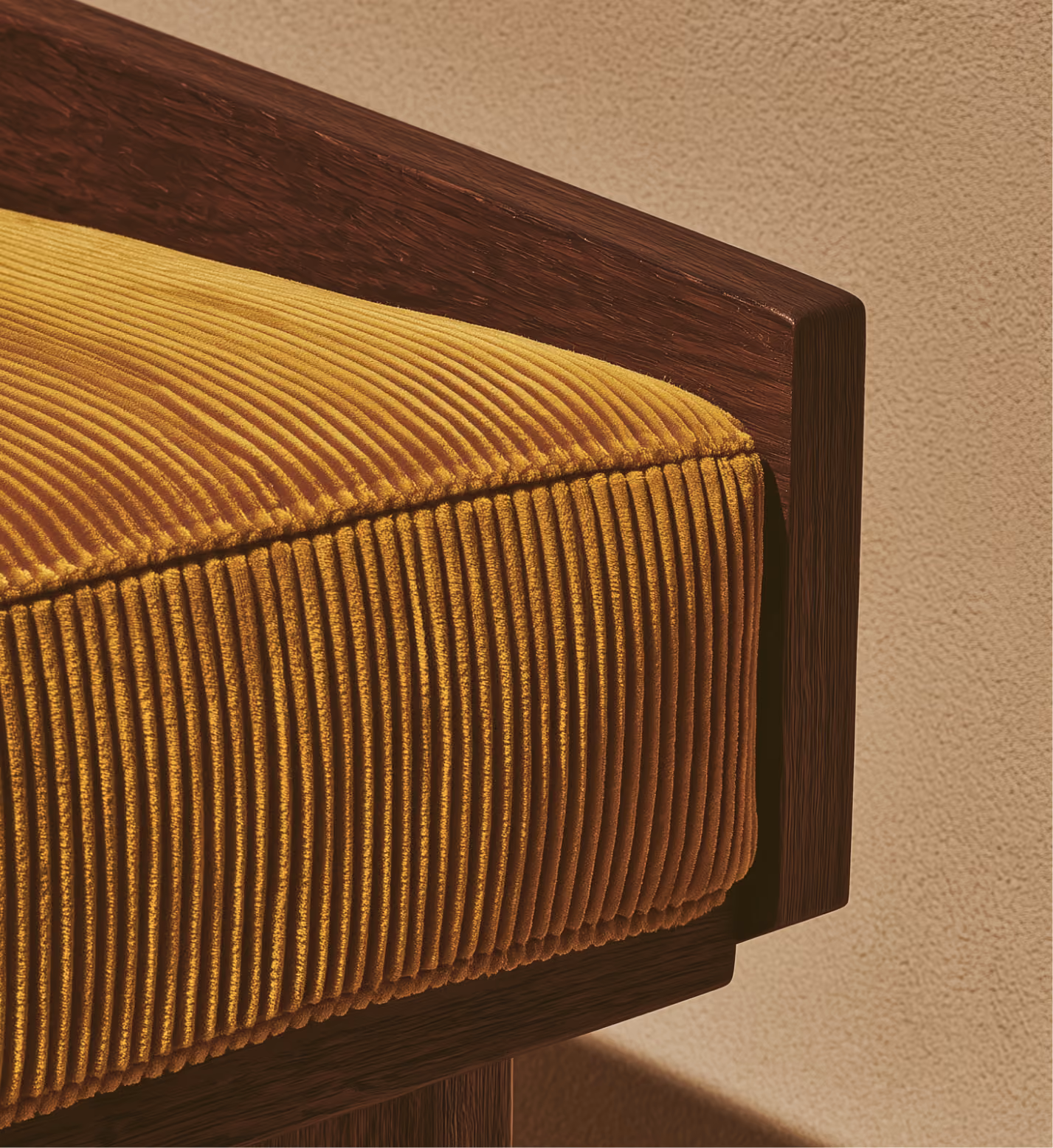 Close-up of a yellow corduroy cushion on a dark wooden chair against a textured beige wall.