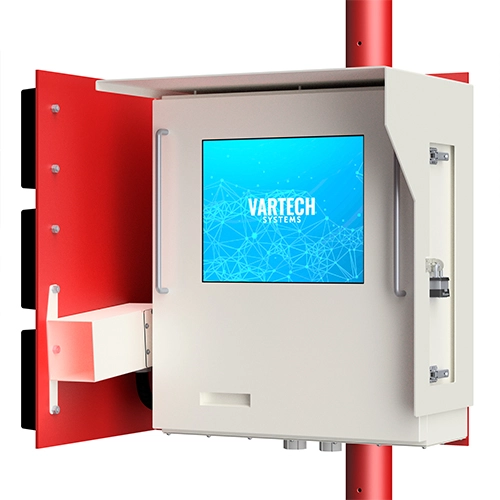 White industrial control box with screen displaying 'VARTECH SYSTEMS' mounted on a red pole.