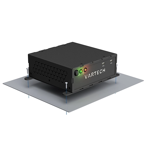 Black VARTECH electronic device with LED lights and USB ports mounted on a gray panel with screws.