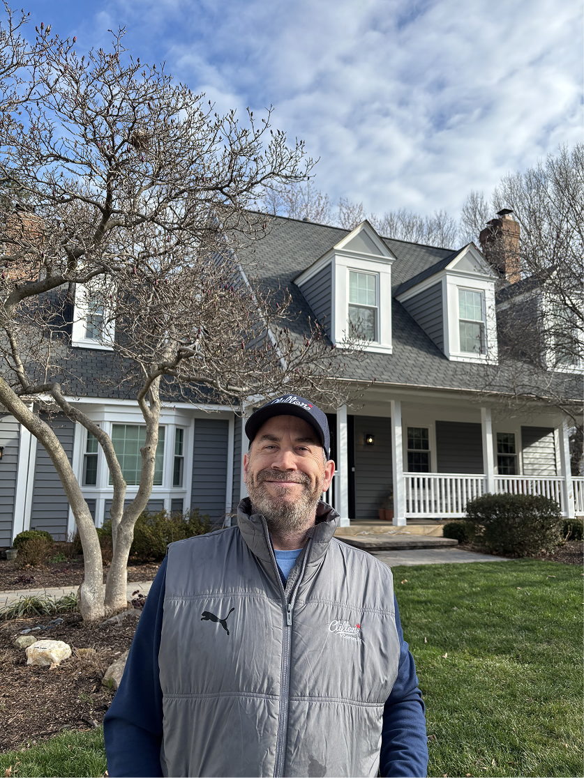 Chris McNulty in front of a house in Clifton, VA that was remodeled by Clifton Exteriors.