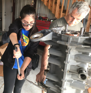 CFTAR mechanic and student working on an aircraft engine in the maintenance shop