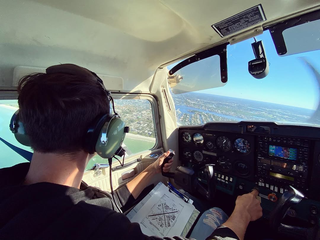 CFTAR student pilot at the controls flying over the Southwest Florida coastline