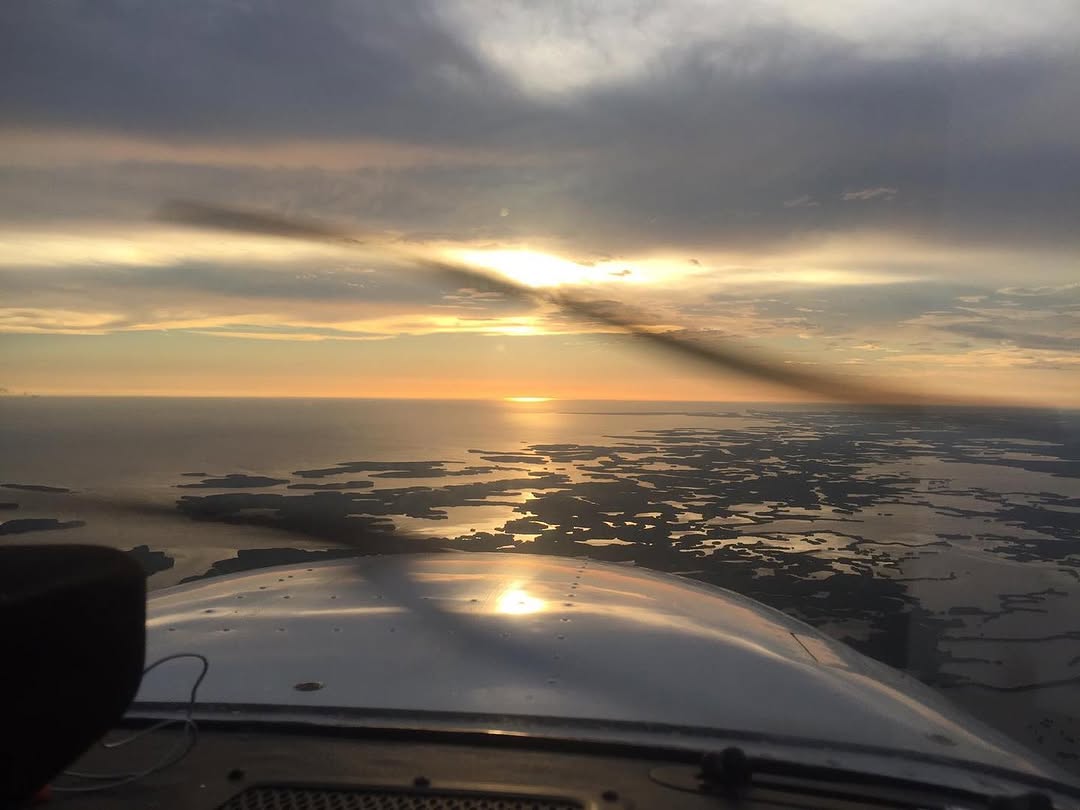 Sunset over the Ten Thousand Islands seen from a CFTAR aircraft on a discovery flight from Marco Island Executive Airport
