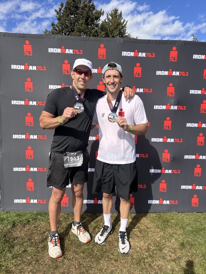Dr. Kelly with his finisher medal at an Ironman 70.3 triathlon
