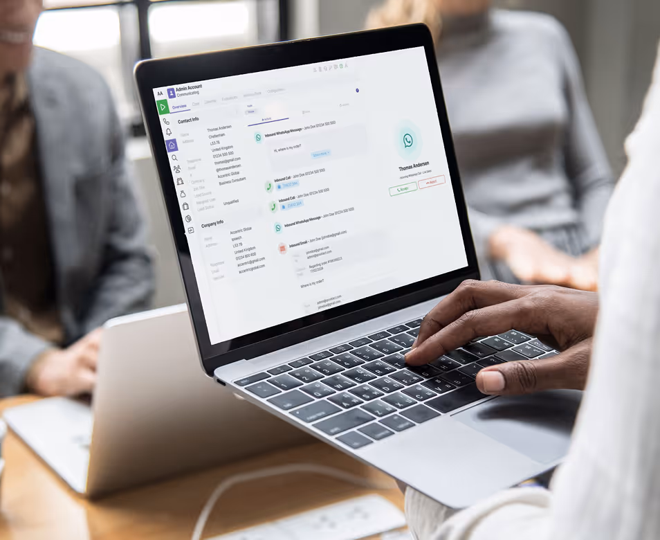 Person using laptop showing a customer service messaging interface with contact and company info.