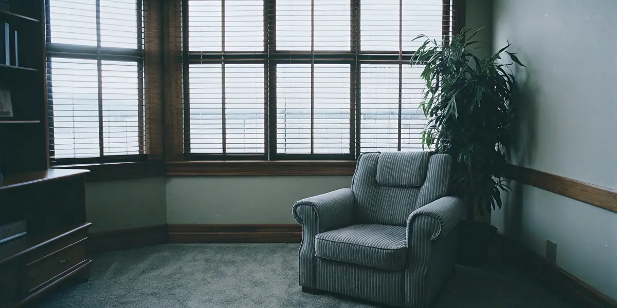 A calm, professional clinical counseling room at Renewal of the Mind in Northern Virginia with soft natural light, comforting wooden elements, and a peaceful atmosphere.