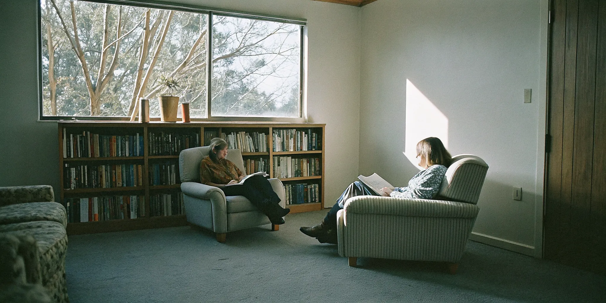 Clinician conducting a VAWA psychological evaluation interview with a client in a comfortable therapy office setting