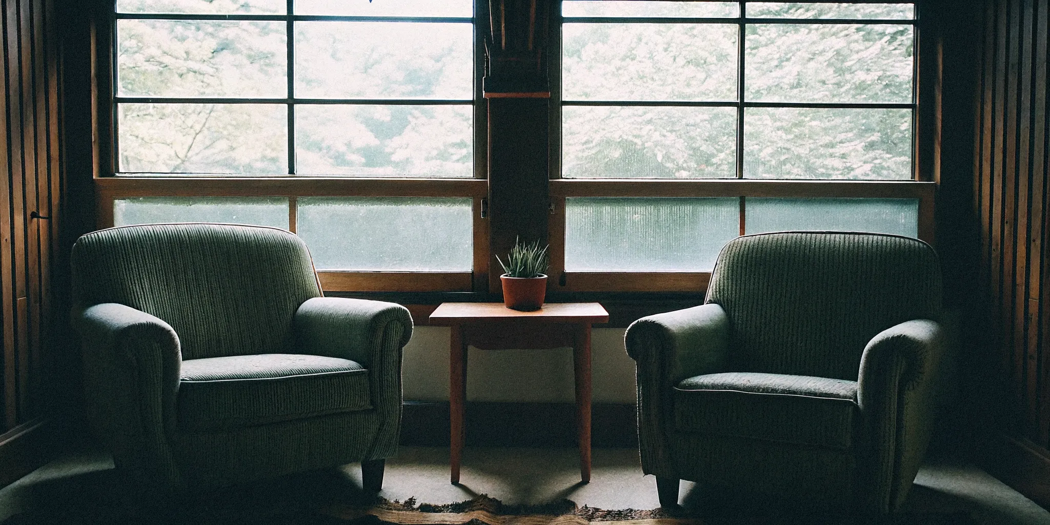 A cozy and welcoming therapist office in Fairfax VA with warm earth tones, soft sunlight, and comfortable seating