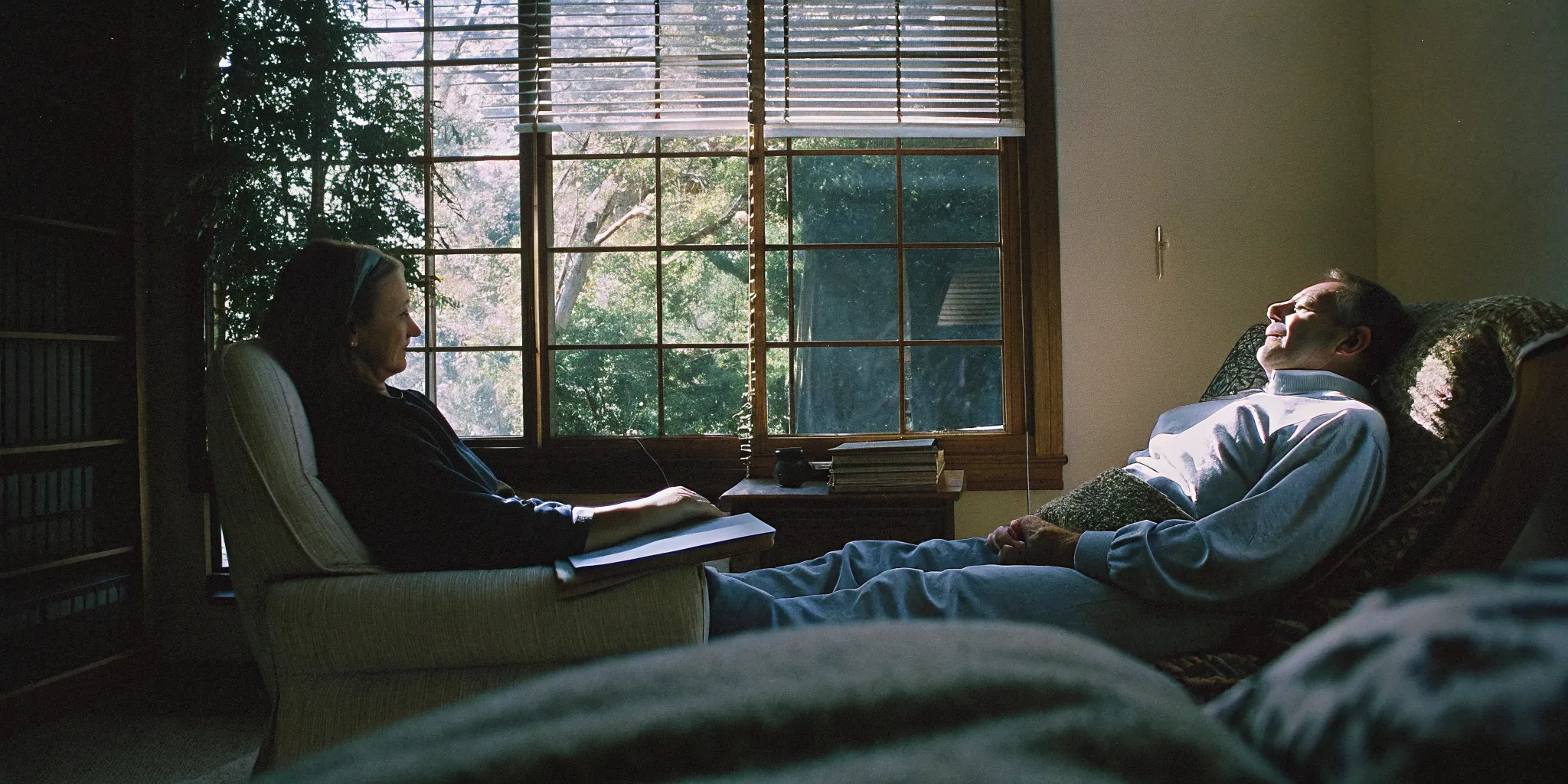 Two therapists working with clients in a warm professional office setting representing EMDR and talk therapy approaches