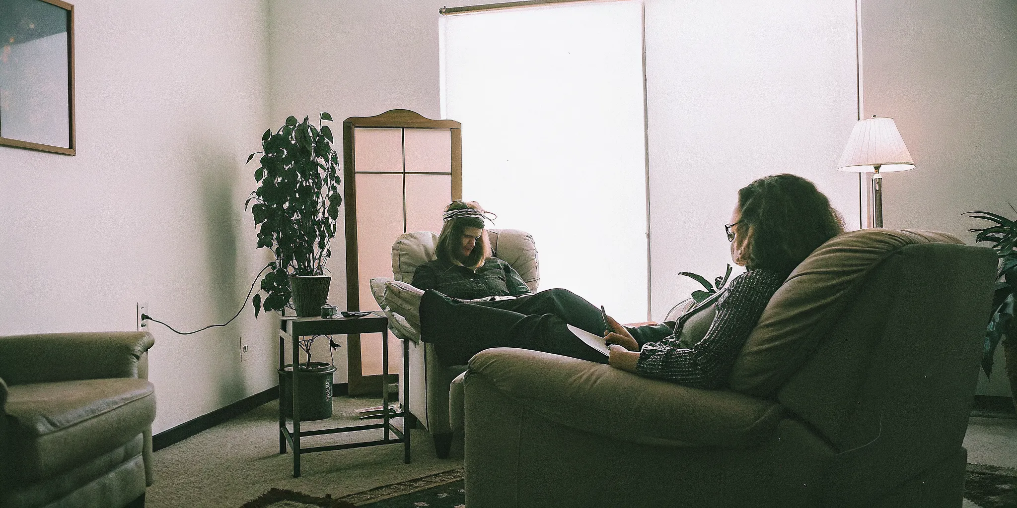 Supportive therapy session with a counselor in a warm office setting