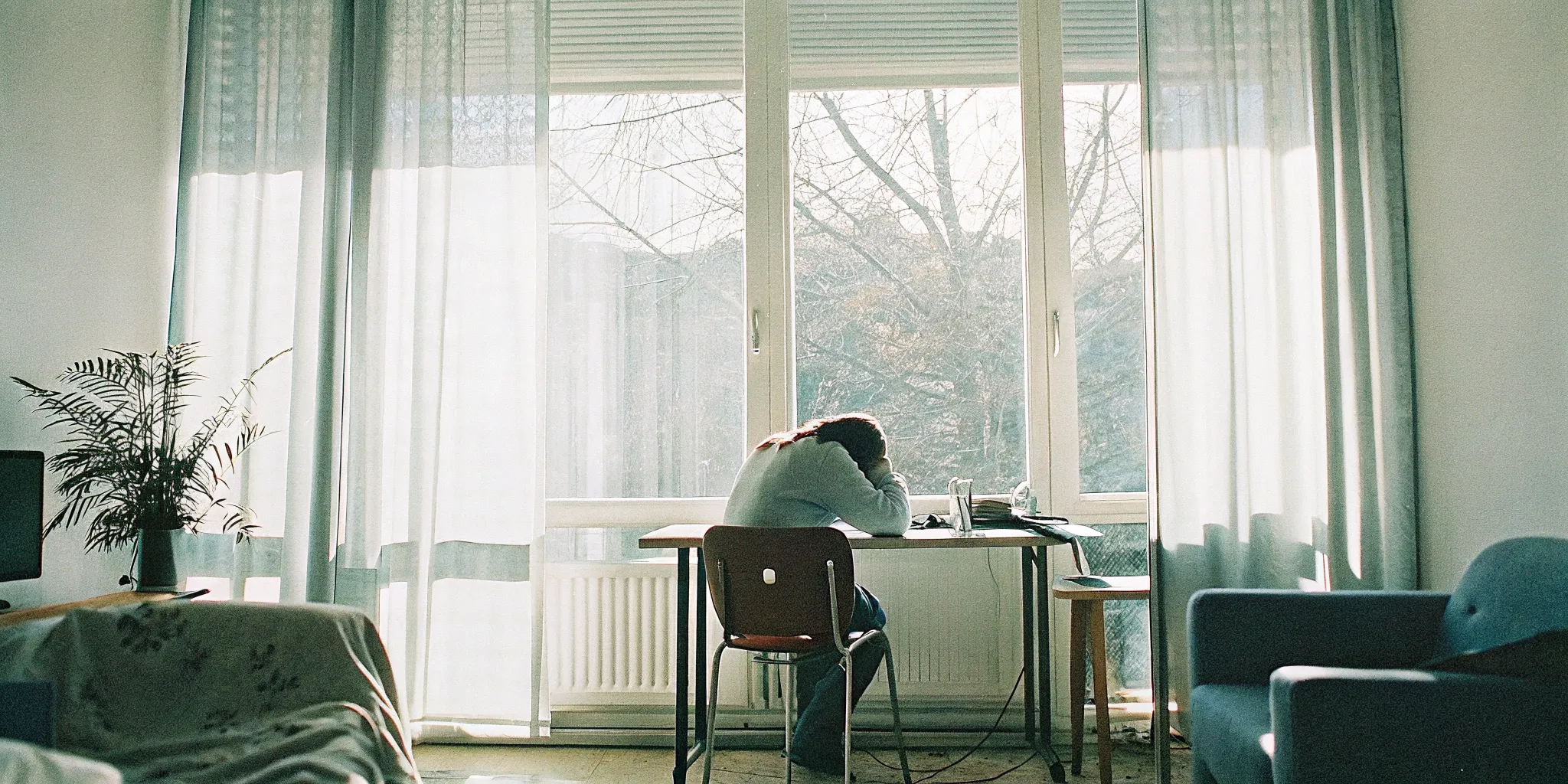 Professional feeling exhausted while working at a desk, brain fog and mental fatigue from burnout