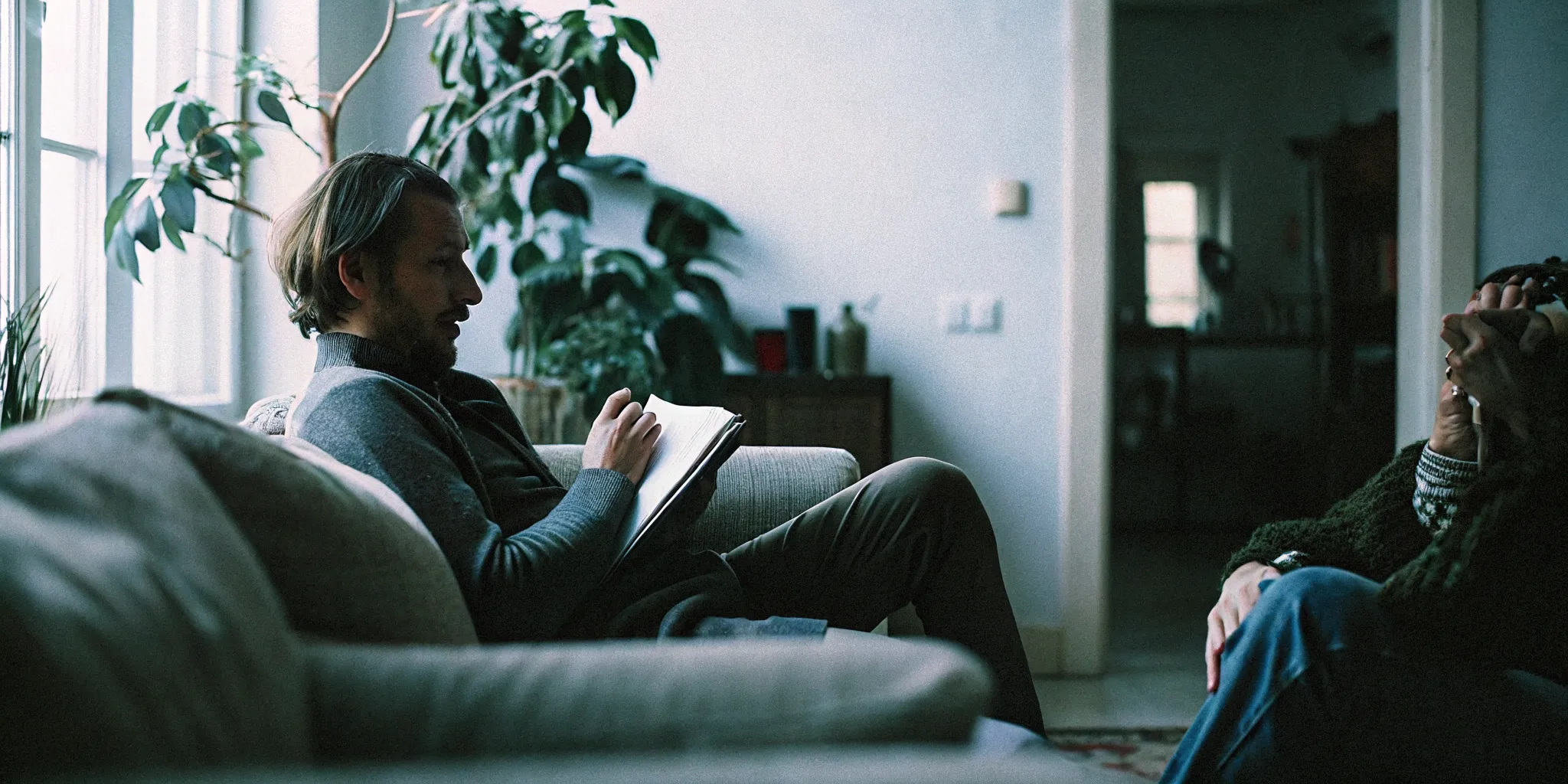 Therapist speaking with a client in a calm, sunlit counseling office