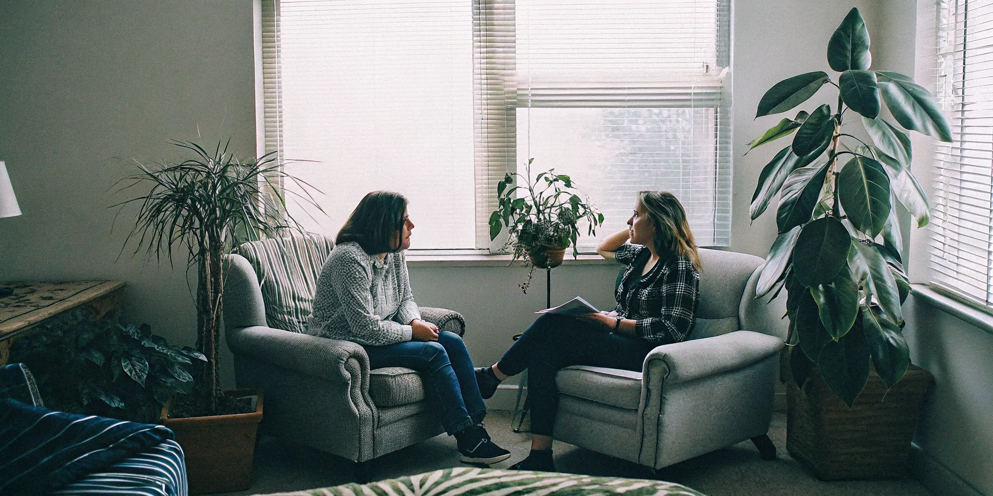 A therapist speaking supportively with an adult client in a calm counseling office in Northern Virginia