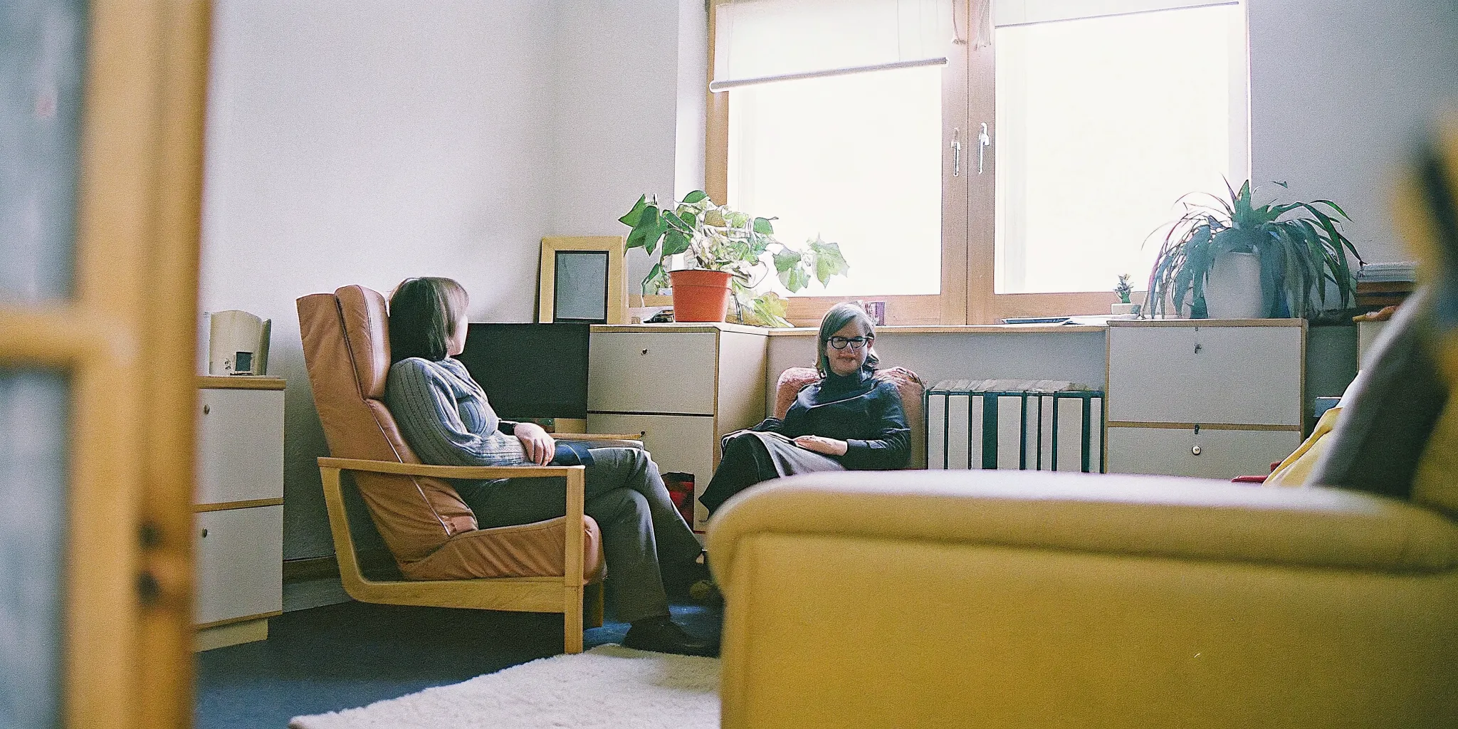 An adult client reflecting quietly during an EMDR session with a therapist in a comfortable Fairfax office