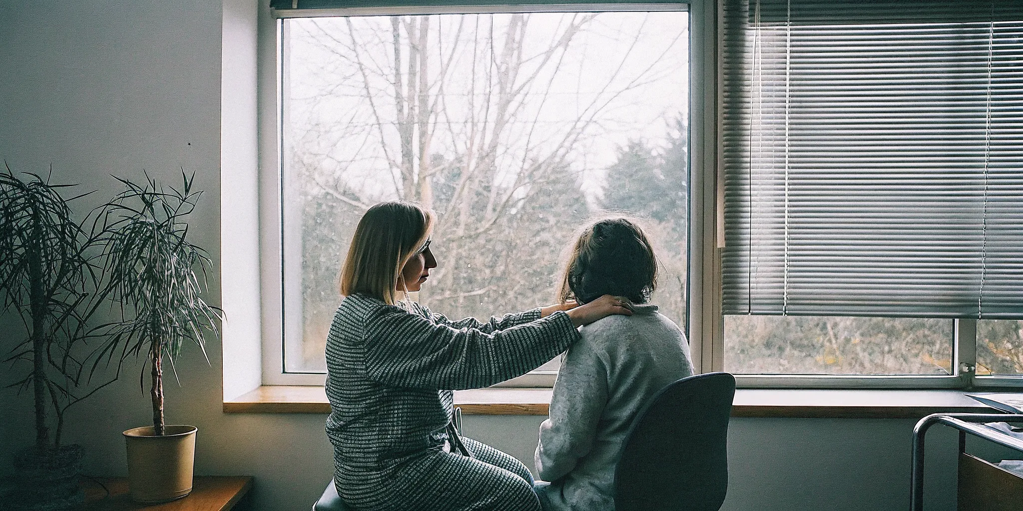 A therapist guiding an adult client through a calm exposure and response prevention exercise in a Fairfax counseling office