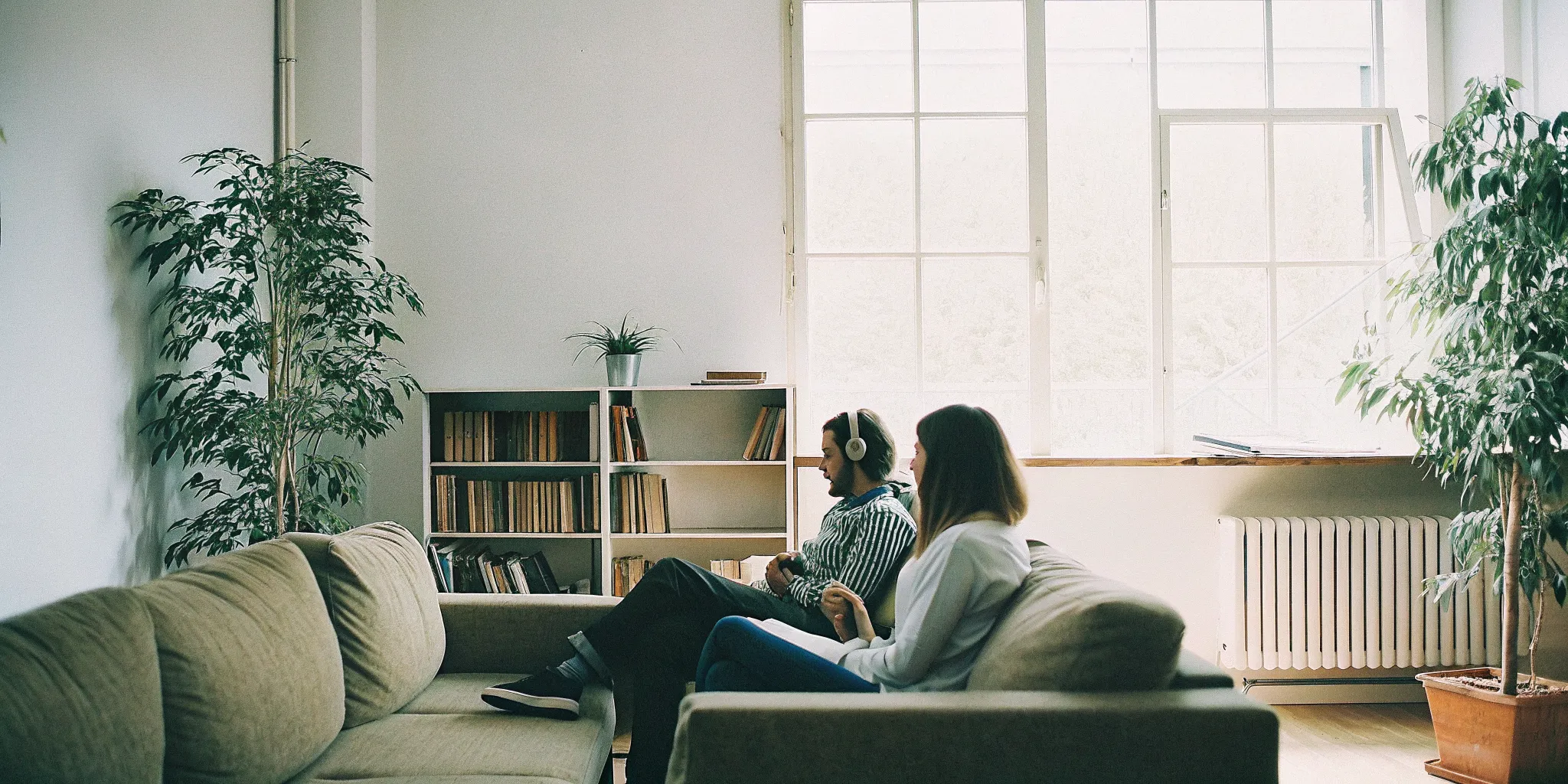 A couple speaking openly with a counselor in a bright, calm therapy office