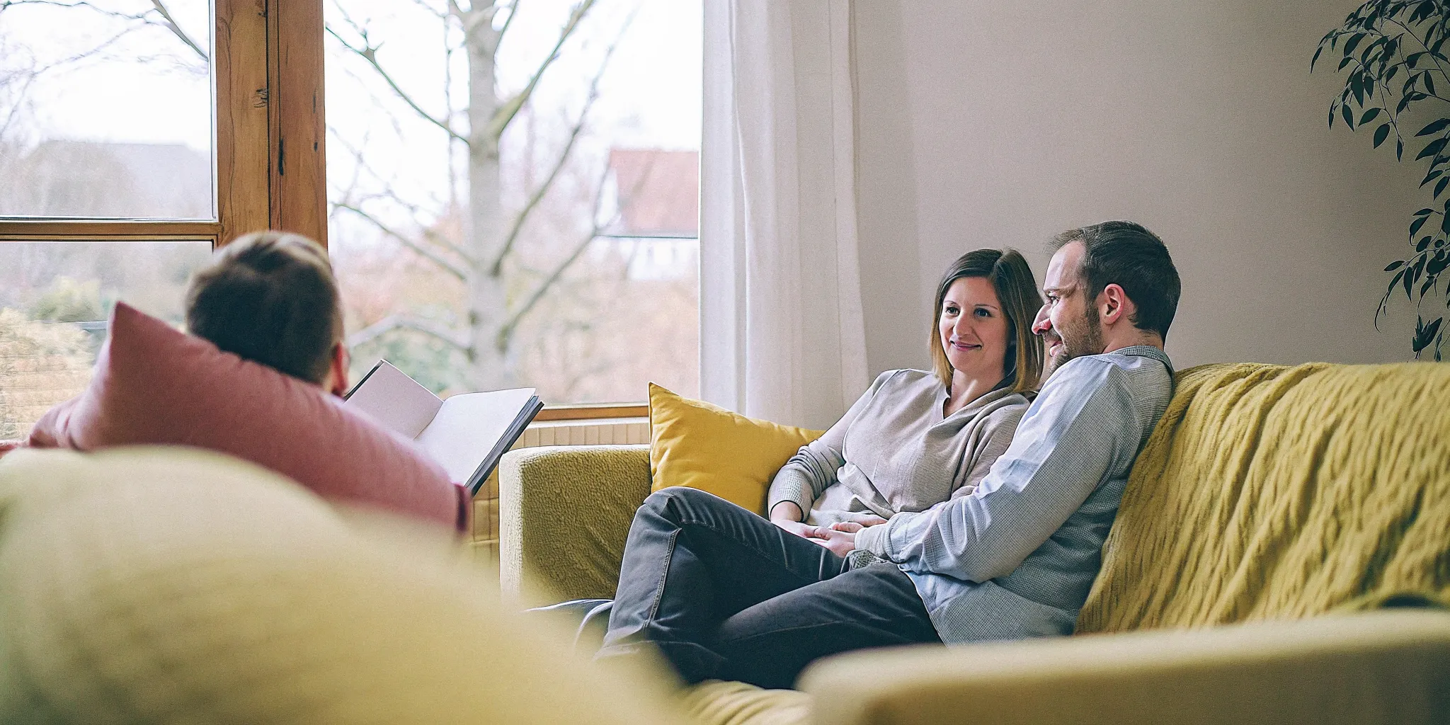 A couple speaking with a licensed therapist in a calm Fairfax counseling office