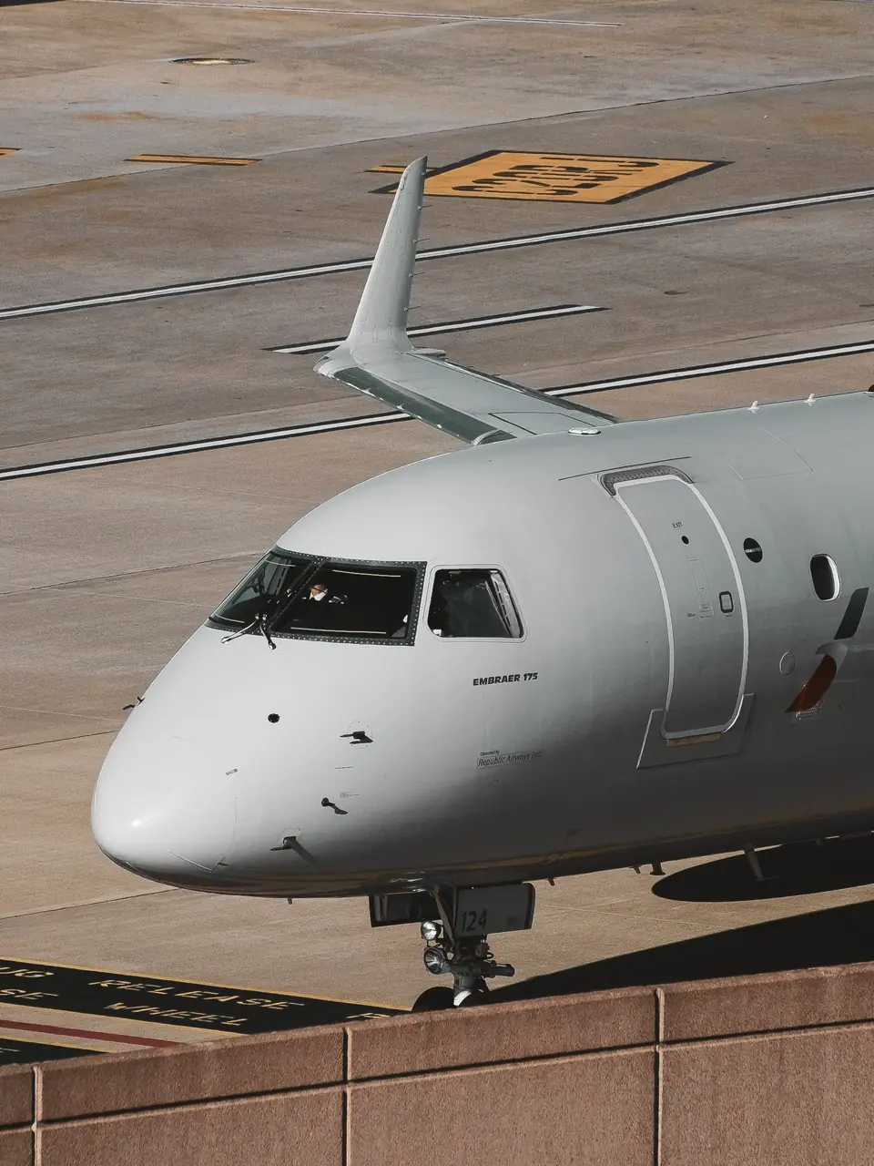 Embraer regional jet taxiing, nose and cockpit seen from above, bespoke private jet and group charter solutions
