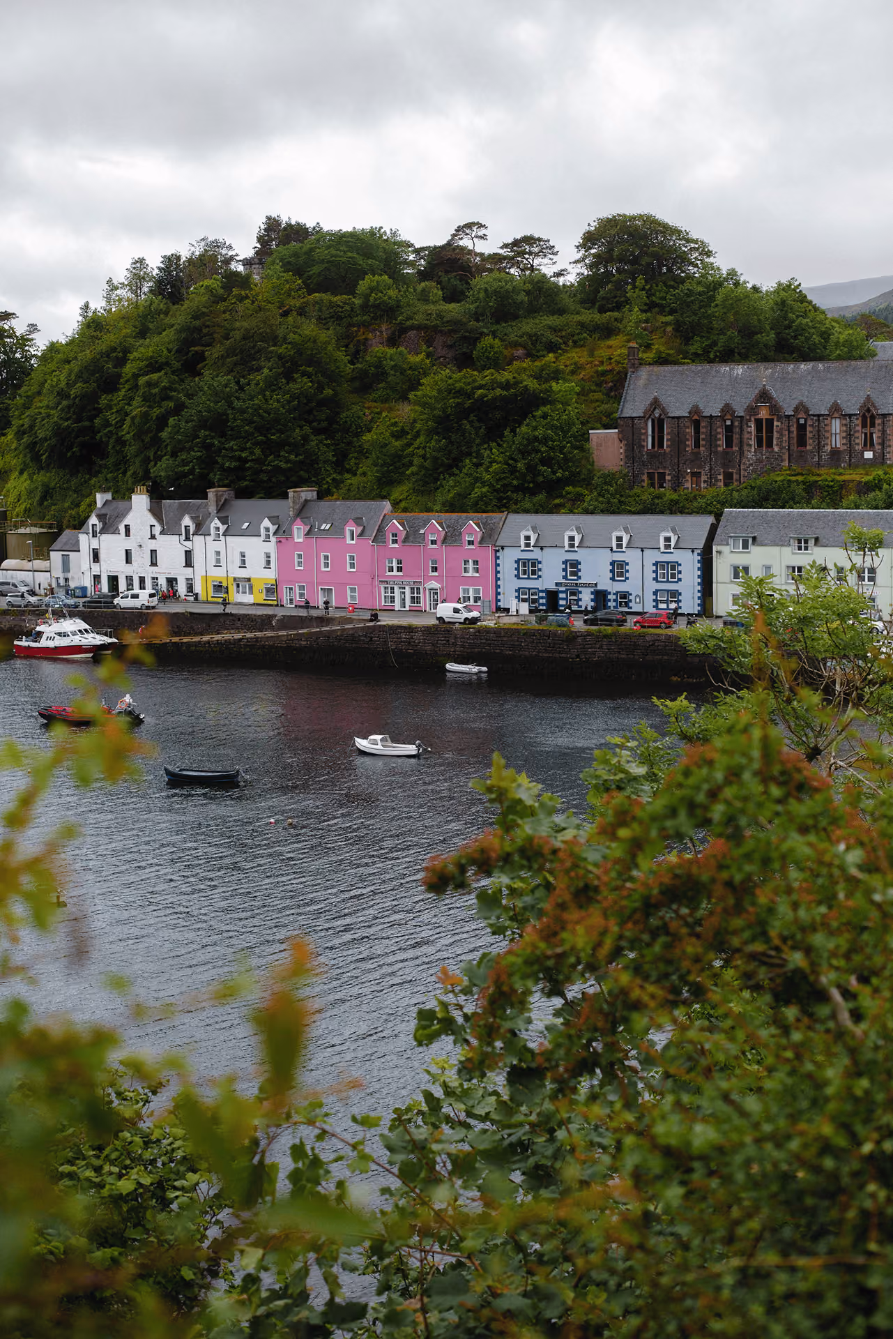 Colorful harbourfront houses in Portree, Isle of Skye, with boats moored in the bay