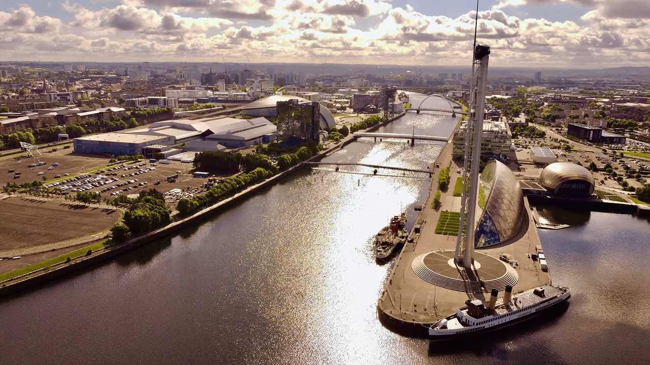 Aerial view of the River Clyde with Glasgow Science Centre, the Clyde Arc bridge and the city spreading into the distance