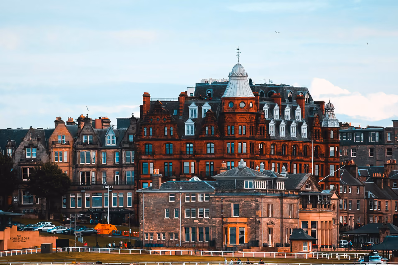 The grand Victorian red sandstone Rusacks Hotel towering above the R&A clubhouse on the St Andrews Links on a warm summer evening