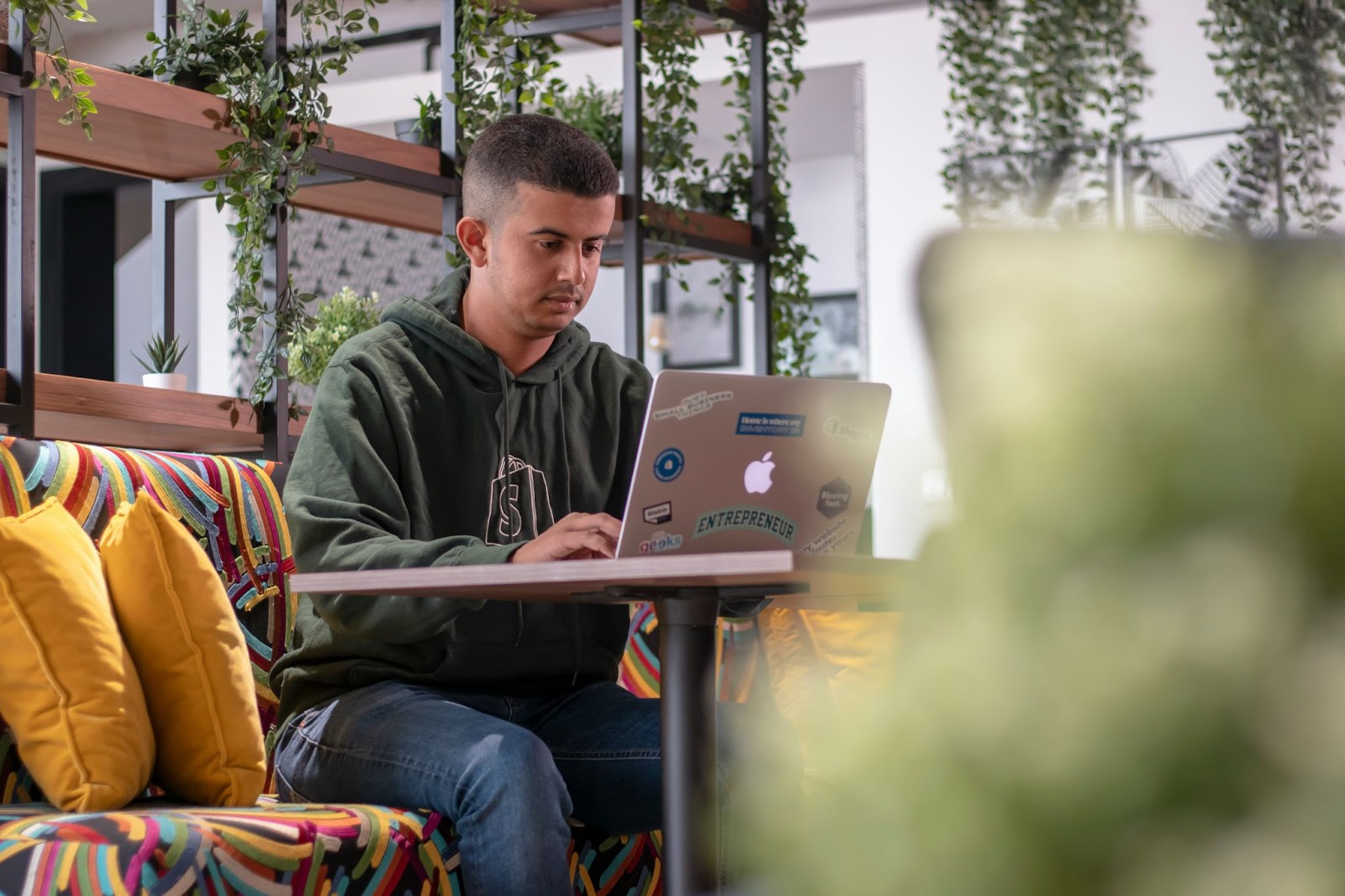 man typing on laptop in coworking space