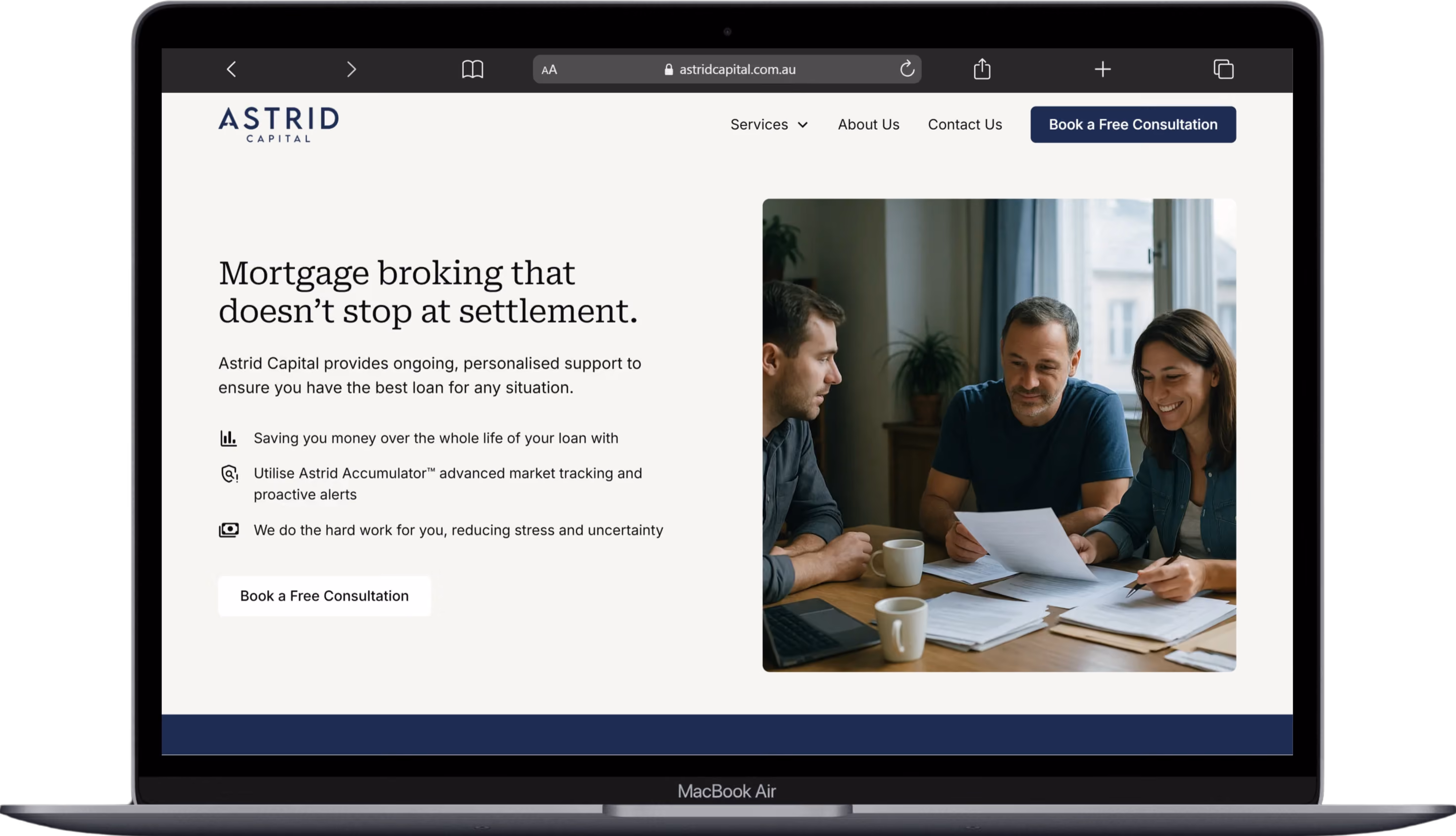 Three people reviewing paperwork at a table with coffee cups and a laptop open in front of them.