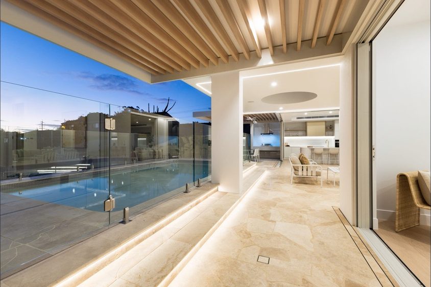 Batten ceiling and glass pool fencing to a covered walkway
