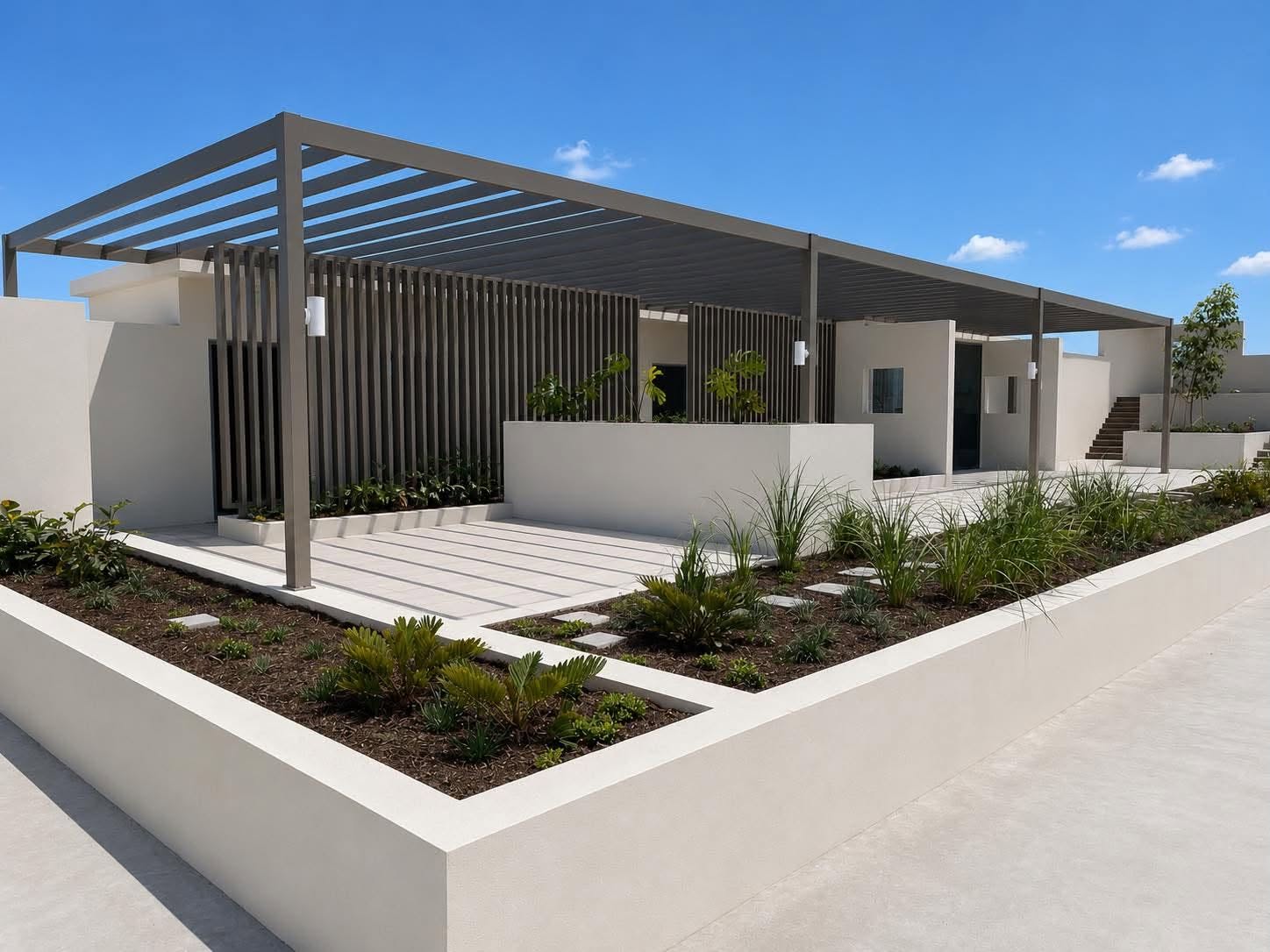 Aluminium batten privacy screen and slatted pergola over a landscaped courtyard entry