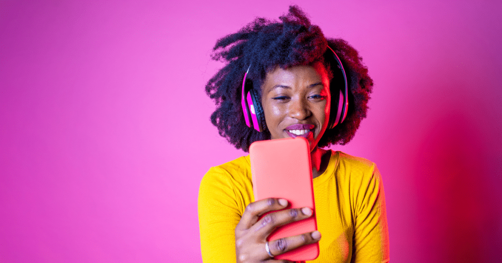 Young Beautiful Black Woman Taking Selfie on Pink Background - IView more by Eugenio Marongiu