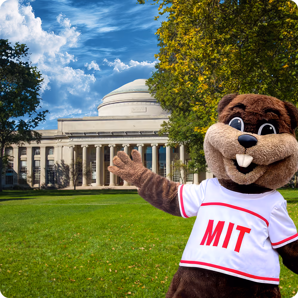 MIT mascot Tim the Beaver giving thumbs up in front of Massachusetts Institute of Technology dome building.