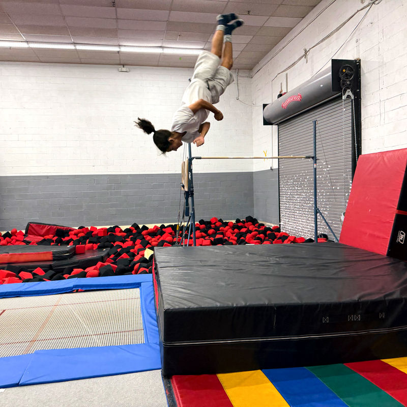 Trampoline and tumbling athlete mid-flip