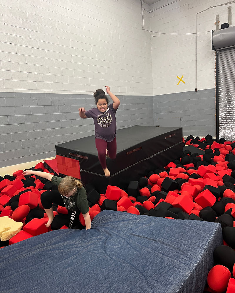 Girls playing in foam pit at Dynamite camp