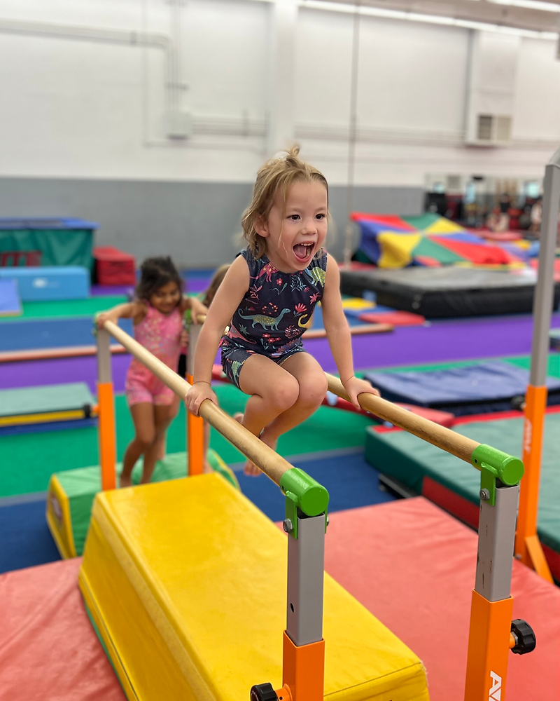 Girl on bars at Dynamite Gymnastics