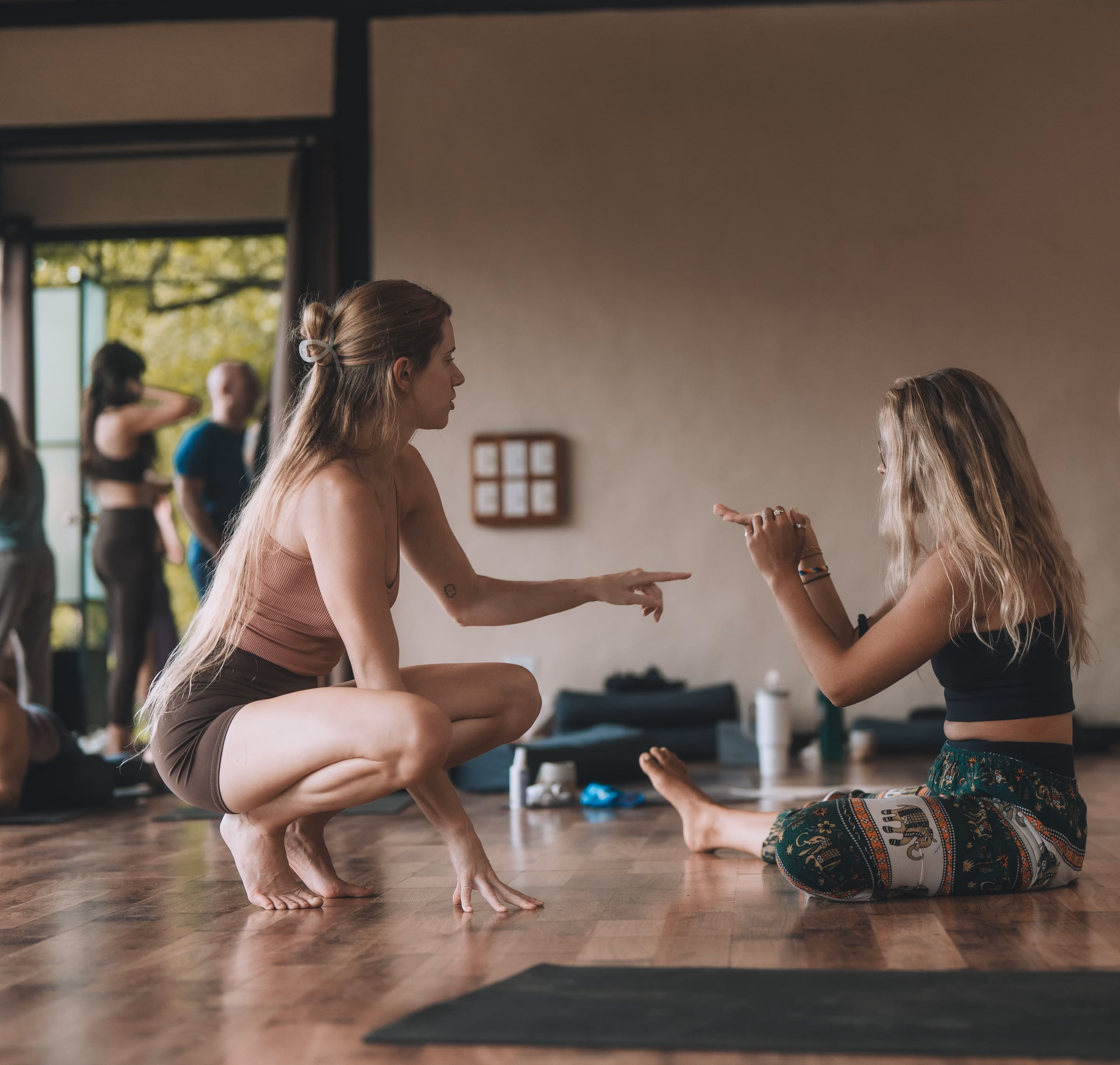 Shawna Krueger talking to yoga student