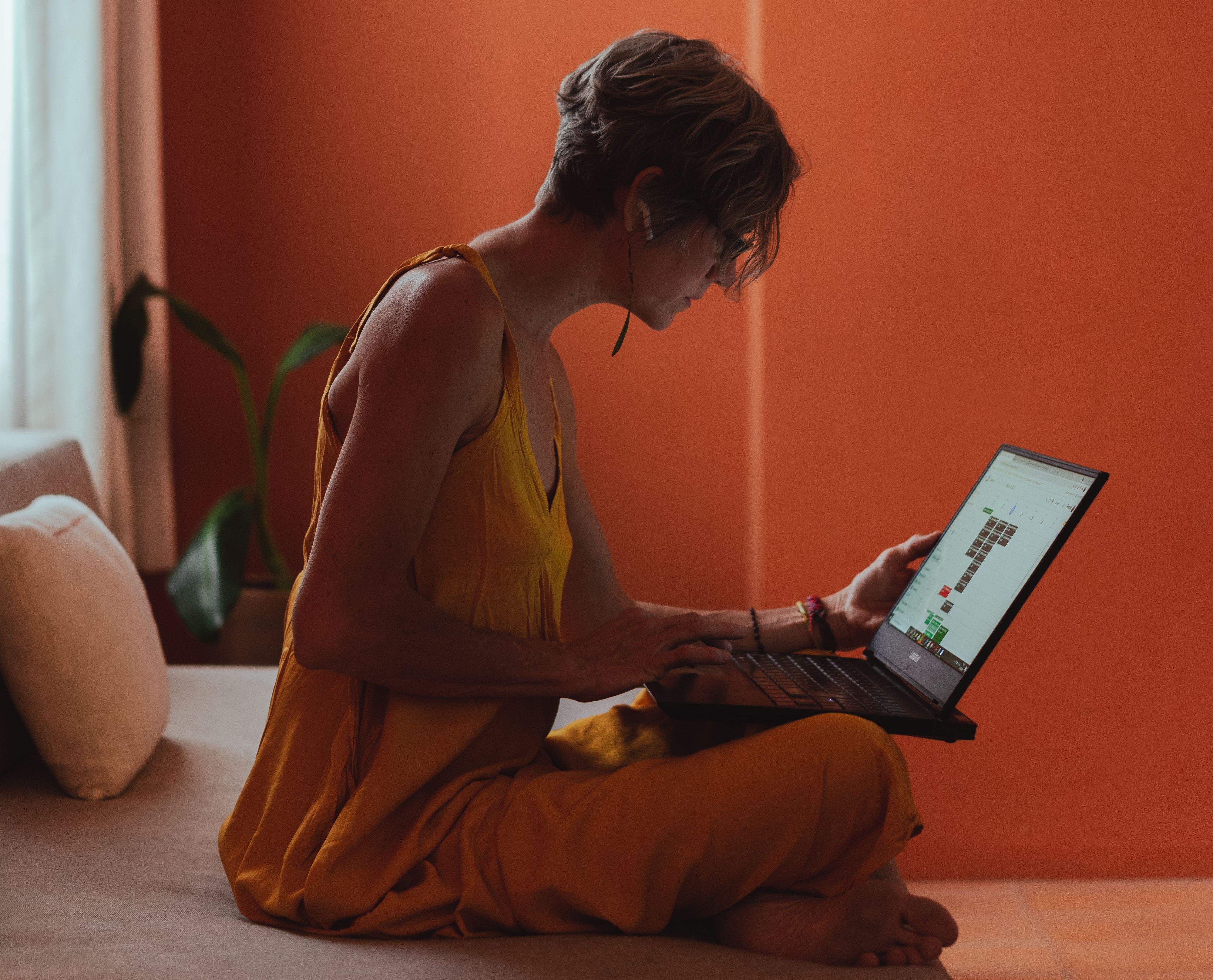 Yoga instructor at computer
