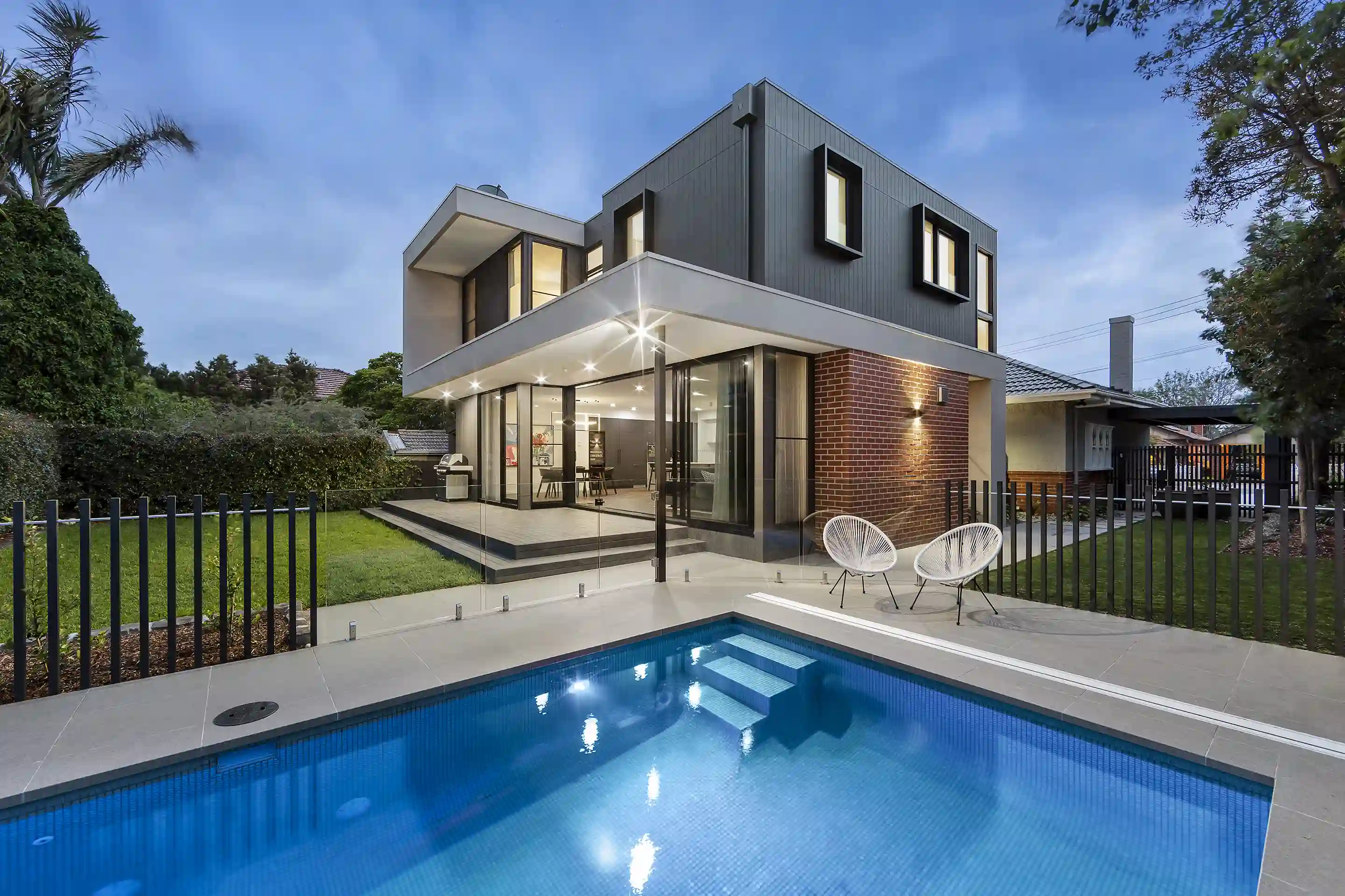 Backyard of a new home with a pool and alfresco seating area