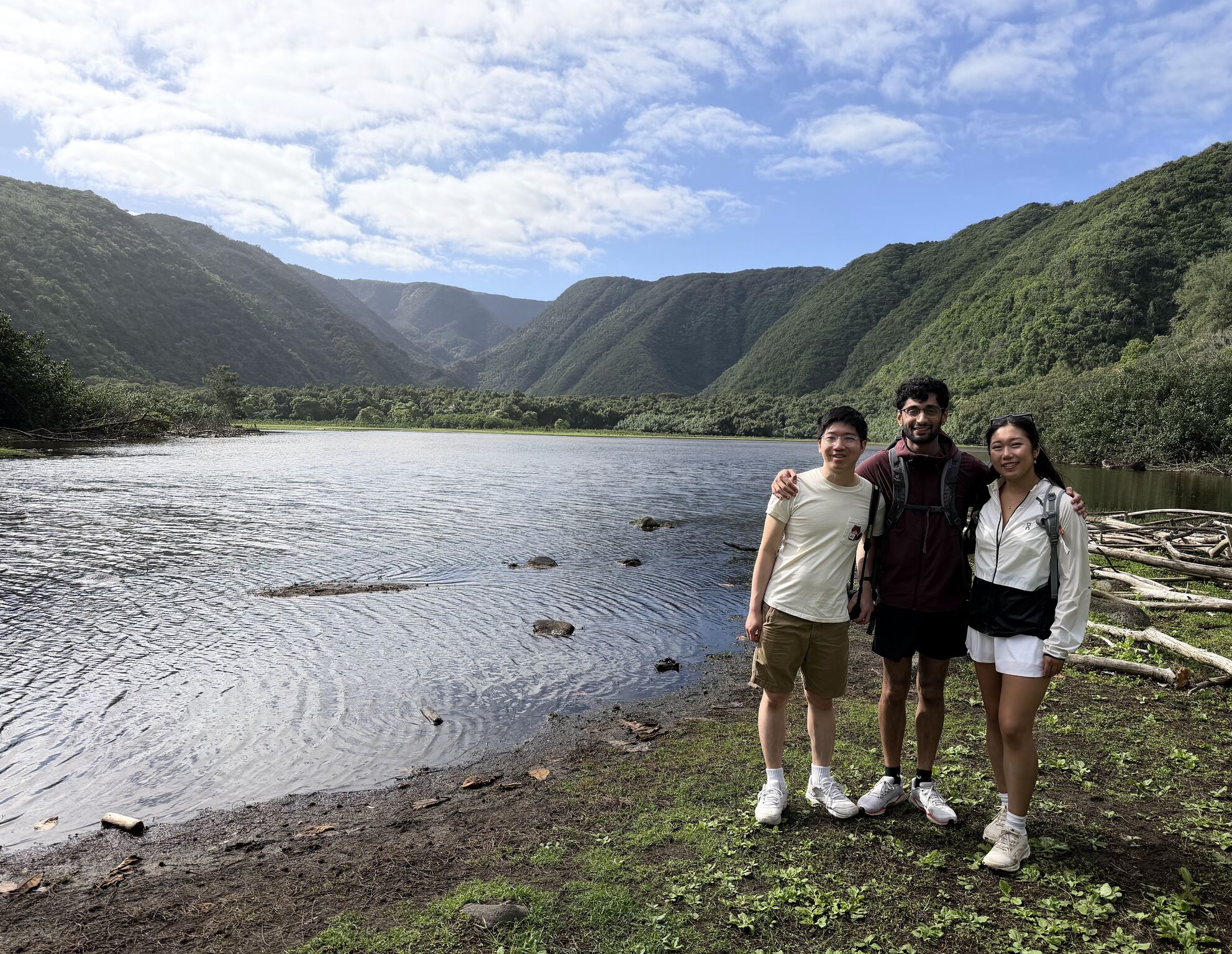 Three Phonic team members beside a mountain lake.