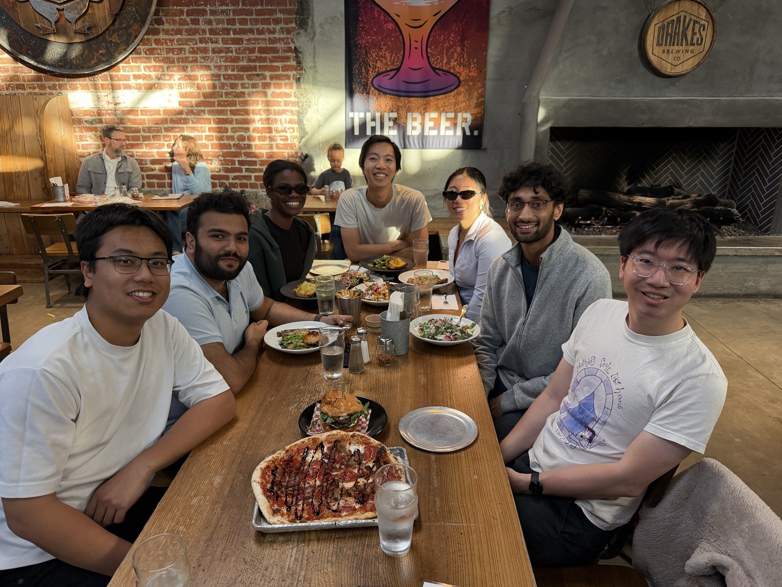 Seven Phonic team members sharing a meal at a restaurant.