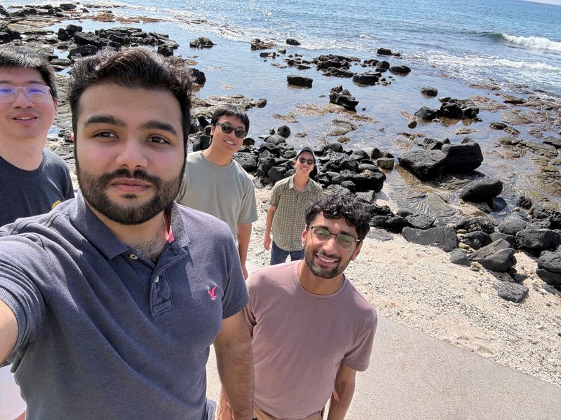 Phonic teammates taking a selfie on a rocky beach