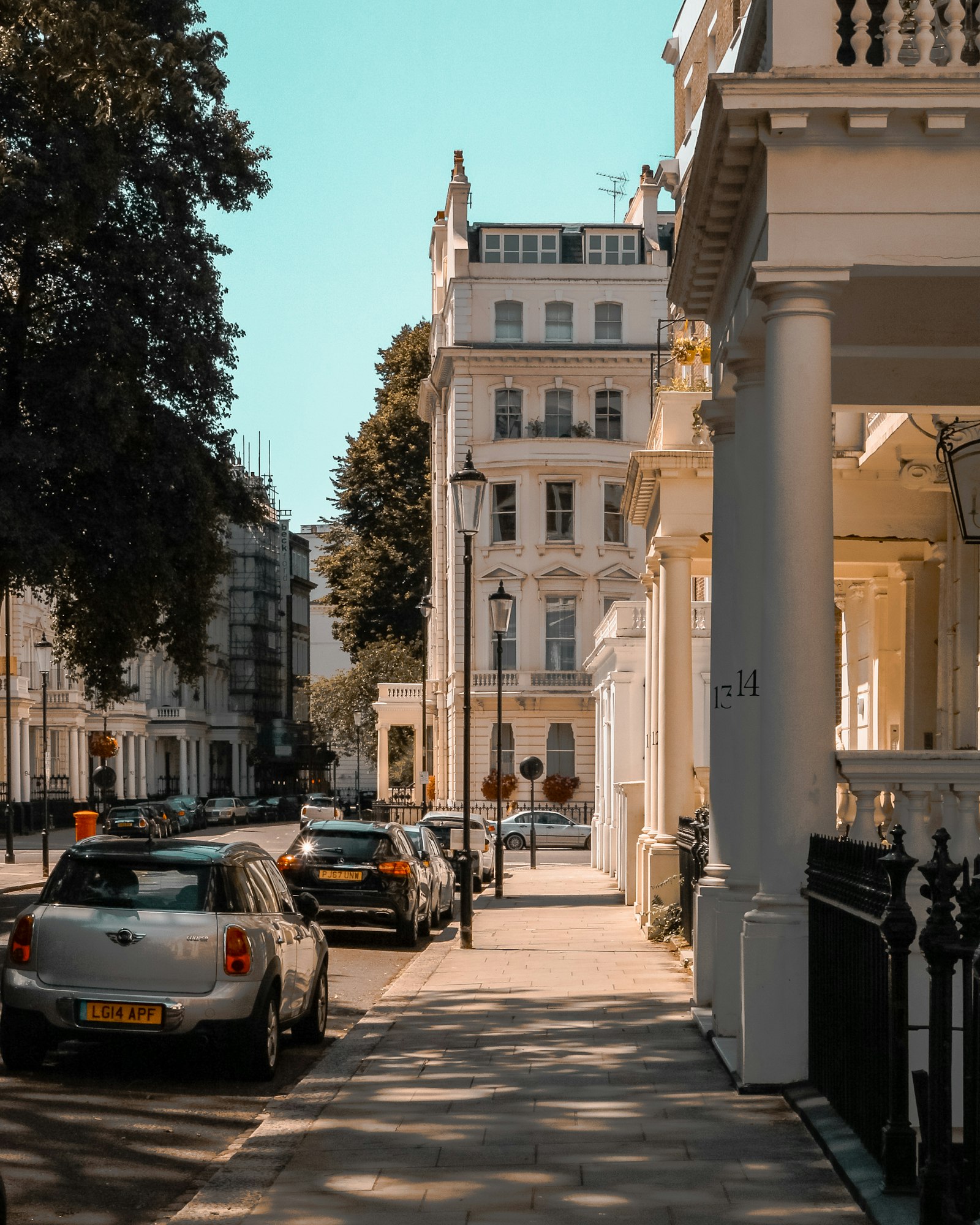 Elegant white stucco period townhouses on a leafy Bayswater terrace