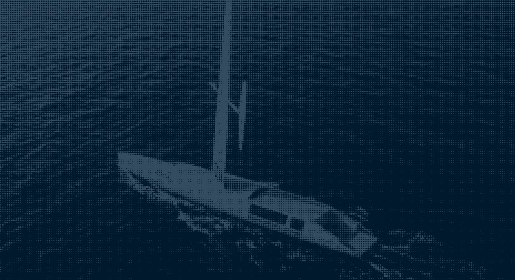 A Saildrone sailing on dark ocean waters, viewed from above.