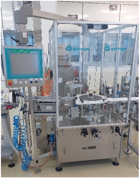 Groninger labelling machine with touchscreen panel and rotary star wheel behind transparent guards