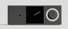 Black digital clock with red indicator light and white circular knob on gray background.